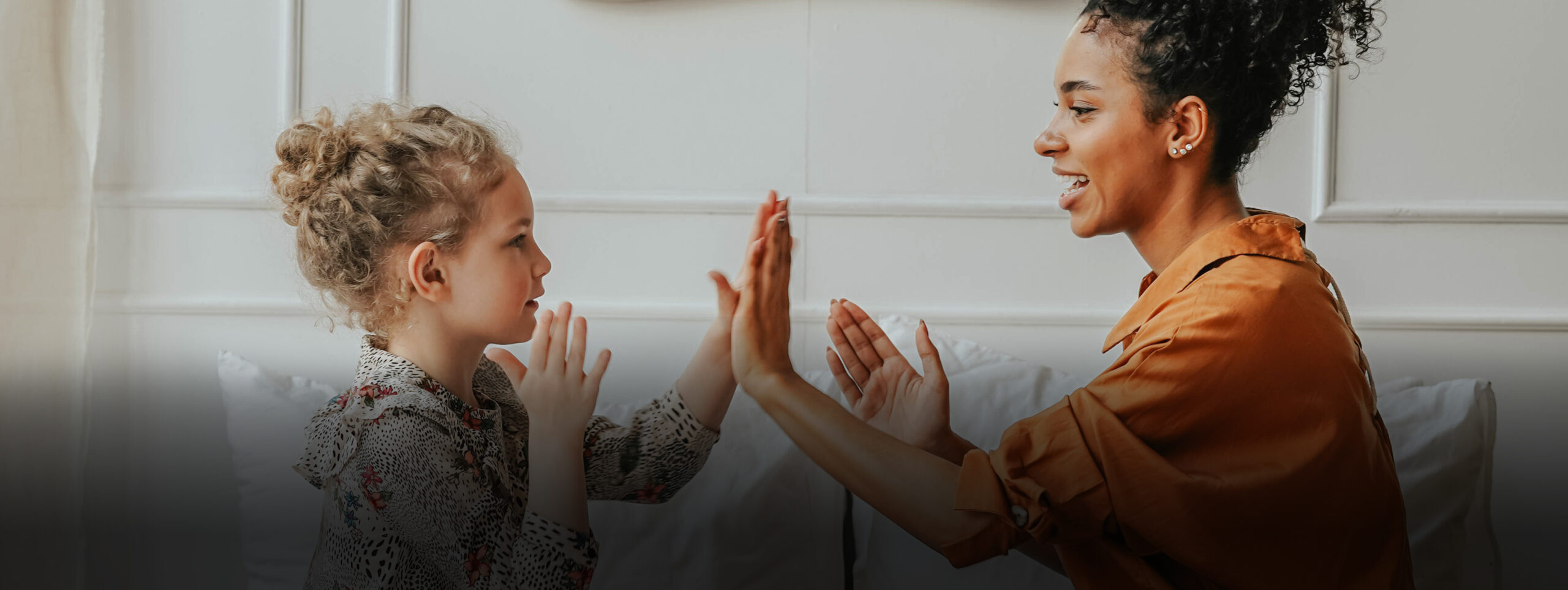 woman and young girl high fiving